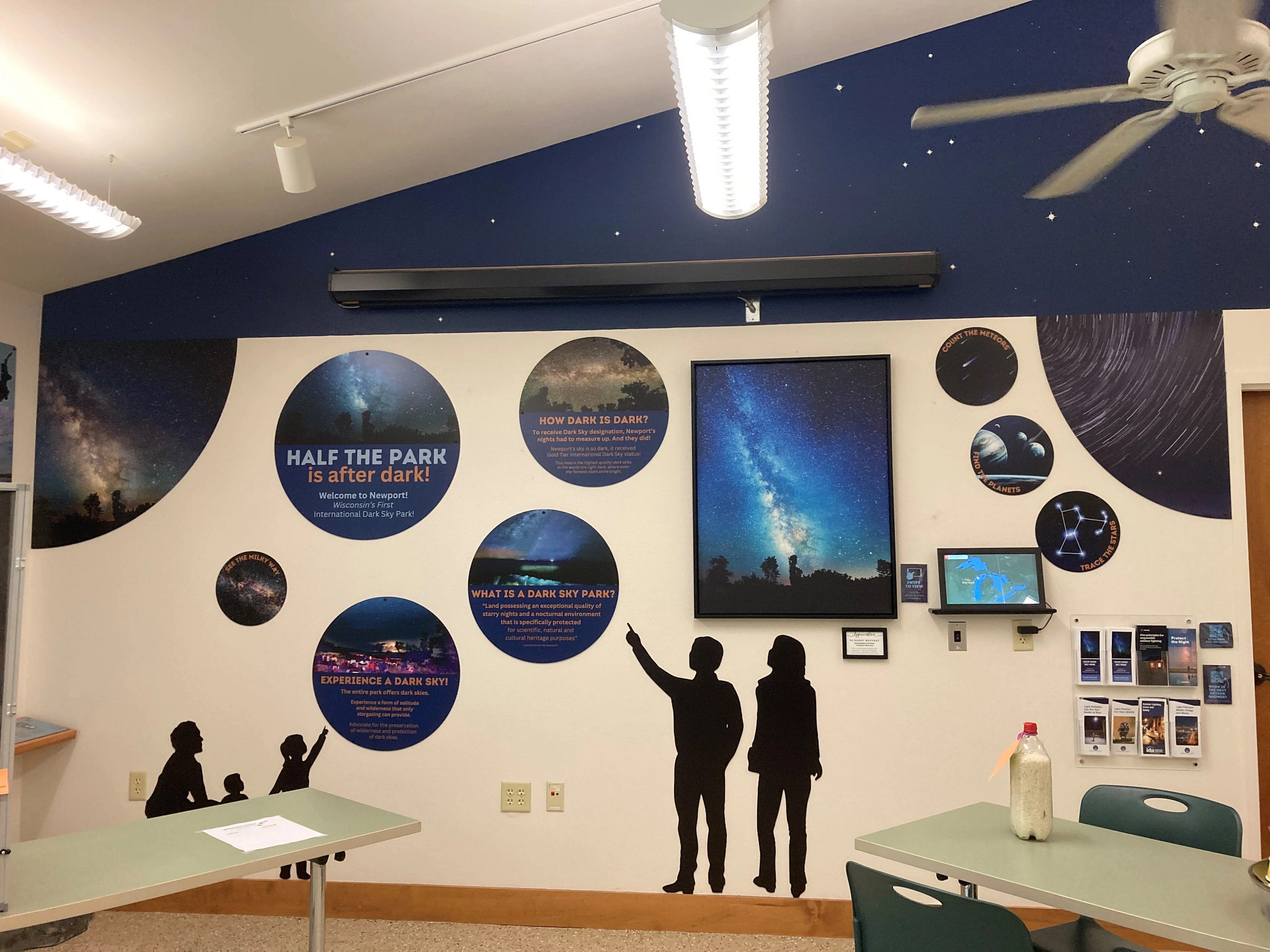 Star and space decals and informational graphics attached to nature center wall.