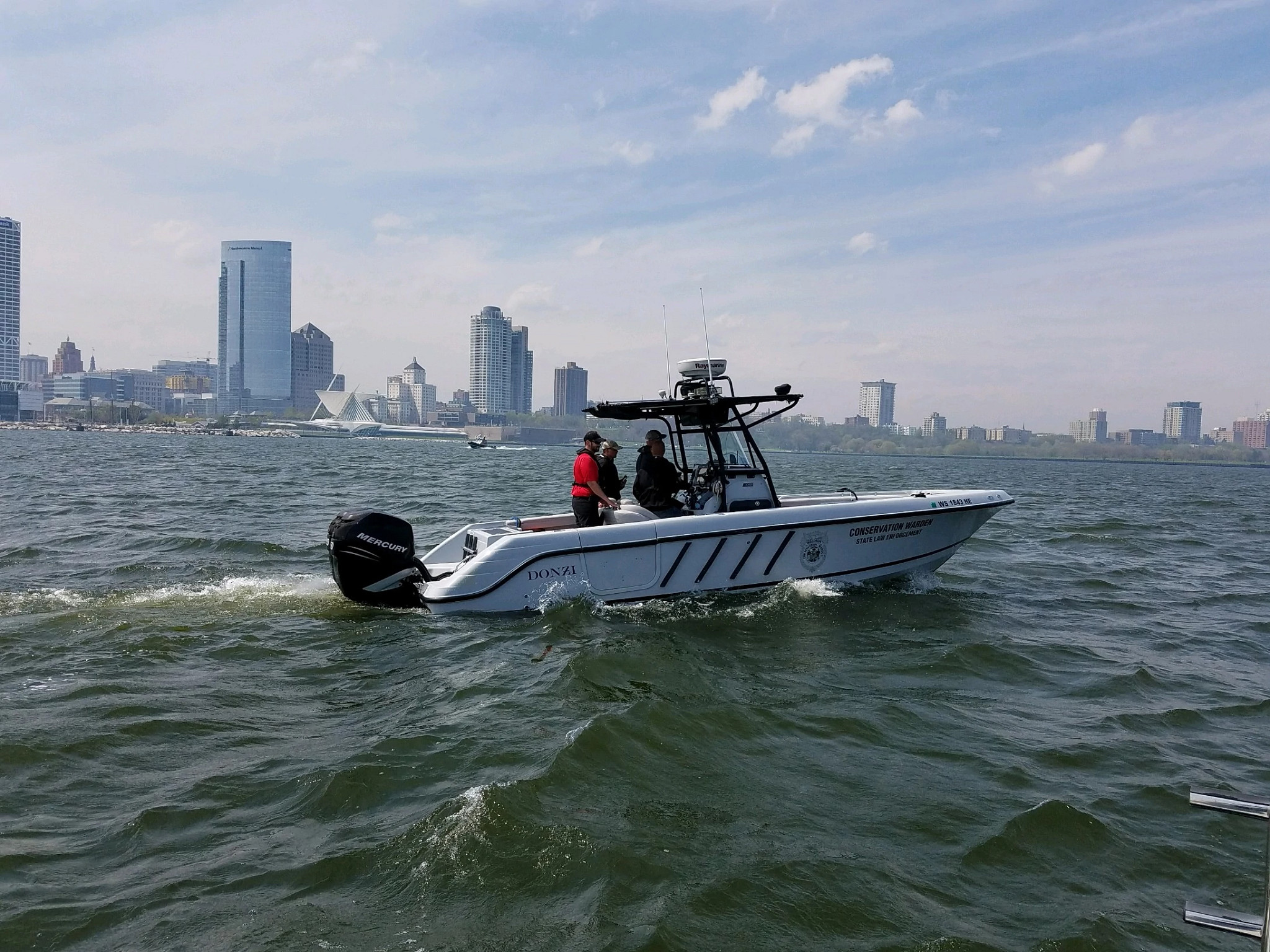 DNR conservation wardens on a DNR boat near the Milwaukee shoreline