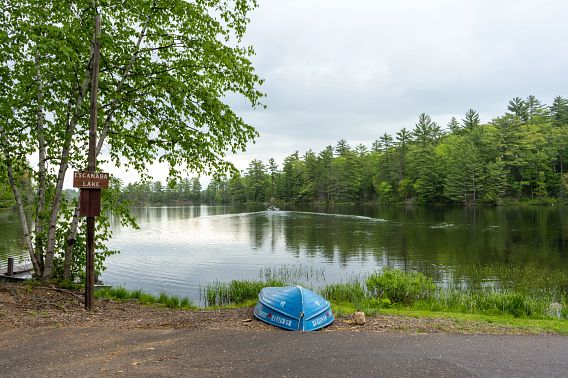 A boat floating along the peaceful waters of Escanaba Lake as viewed from the boat launch.