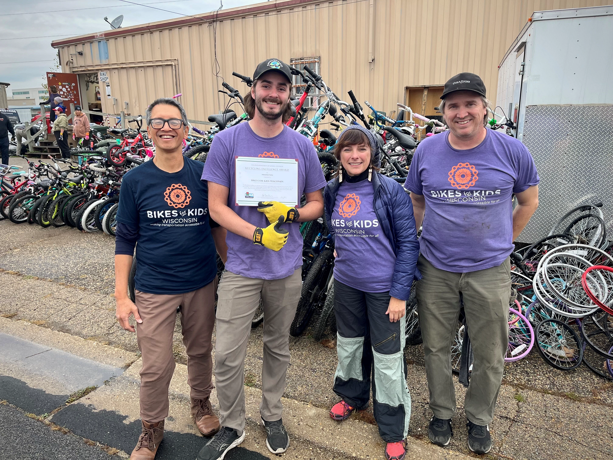 Members of Bikes for Kids Wisconsin posing with Recycling Excellence Award