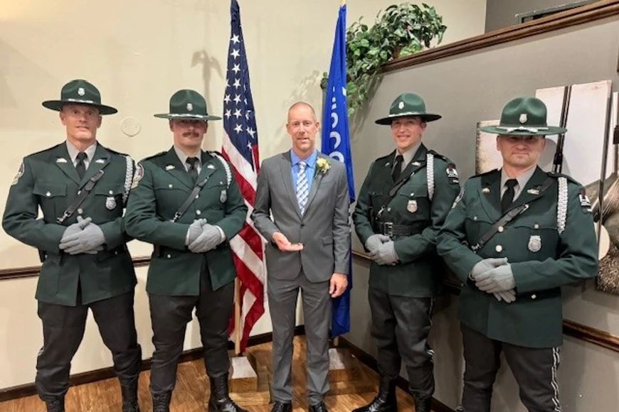 DNR Warden Brandon Smith stands with the DNR Warden Honor Guard.