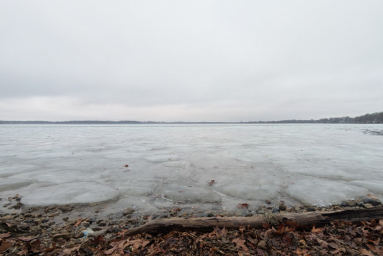 Unsafe, broken ice covers lake.