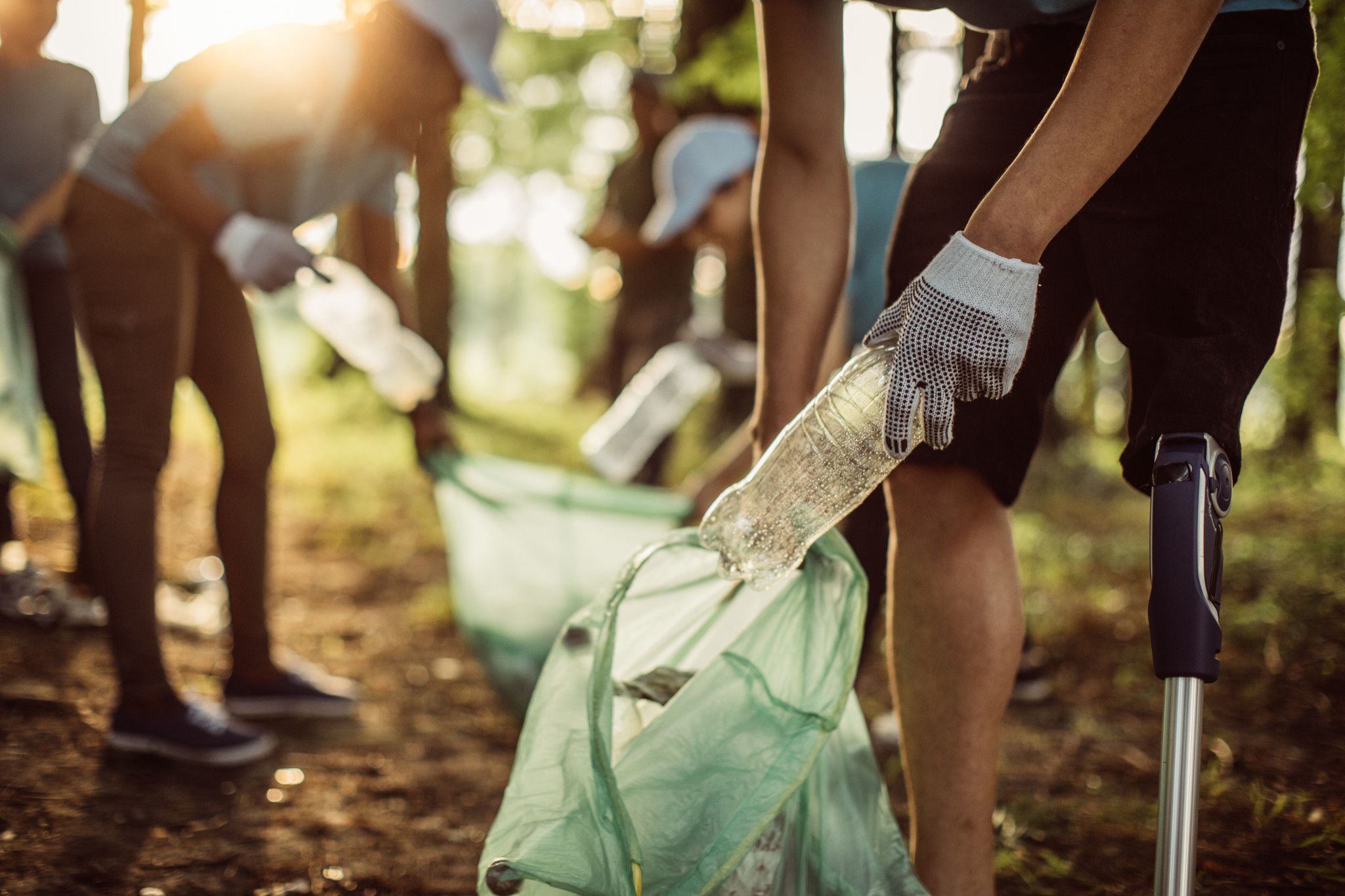 An image of volunteers picking up litter from a park.