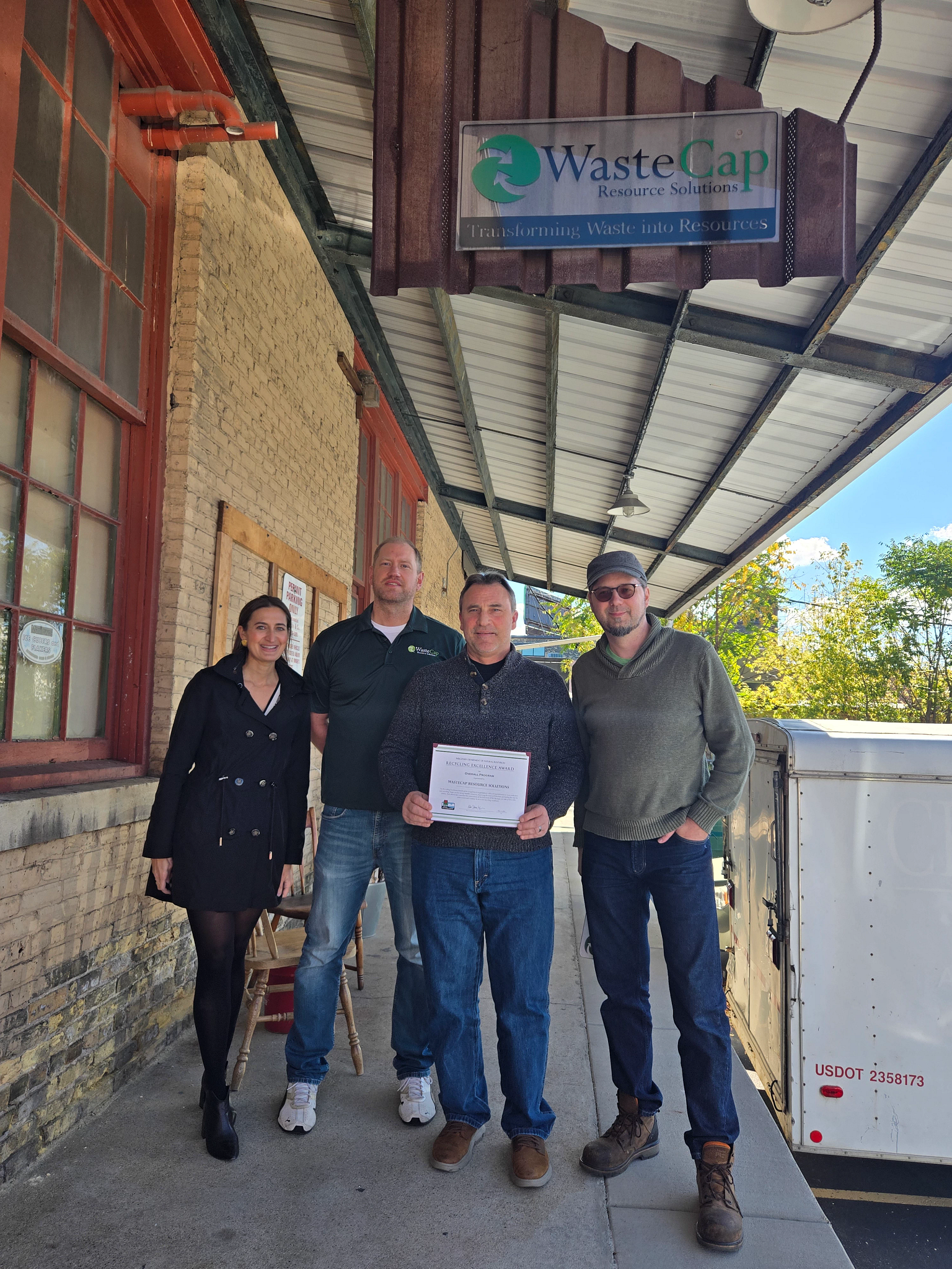 Members of WasteCap Resource Solutions posing with Recycling Excellence Award