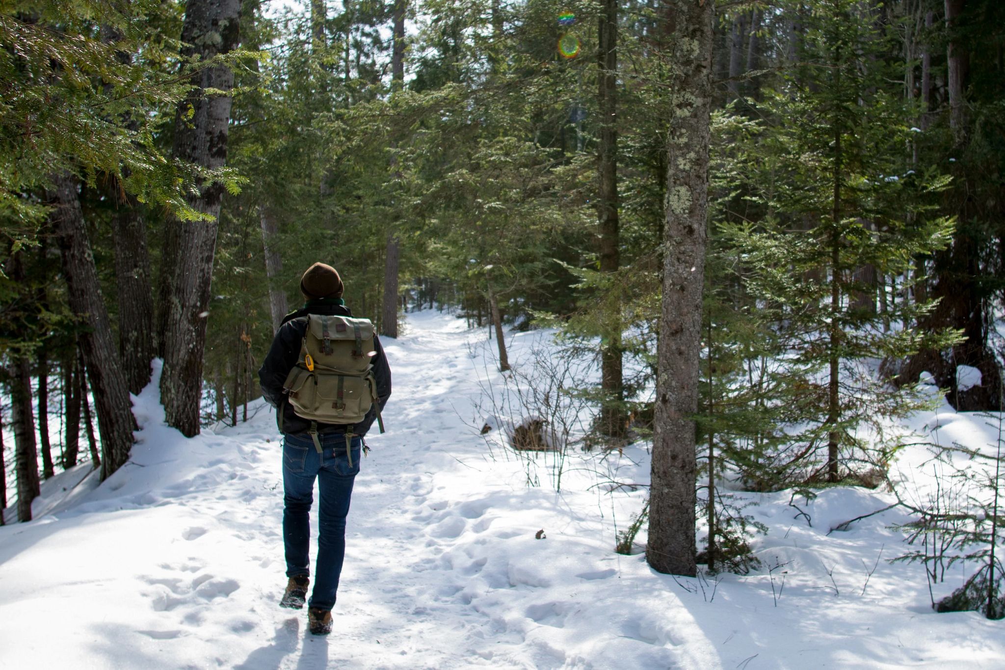 An image of a man walking through Copper Falls, Wisconsin in the winter time. 