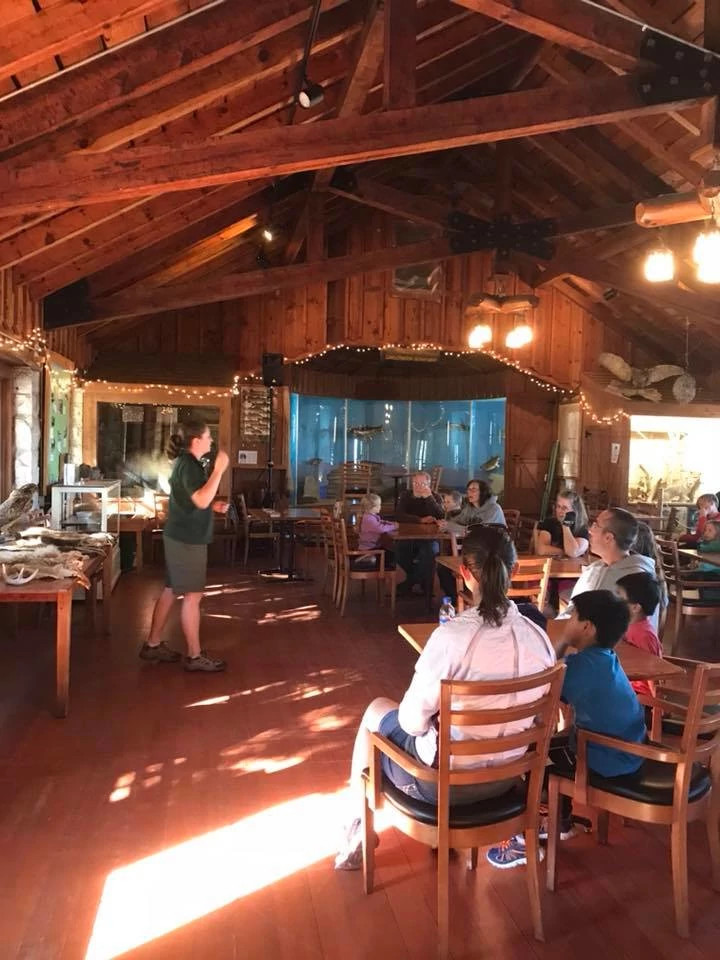 People sit watching a presentation in the nature center.