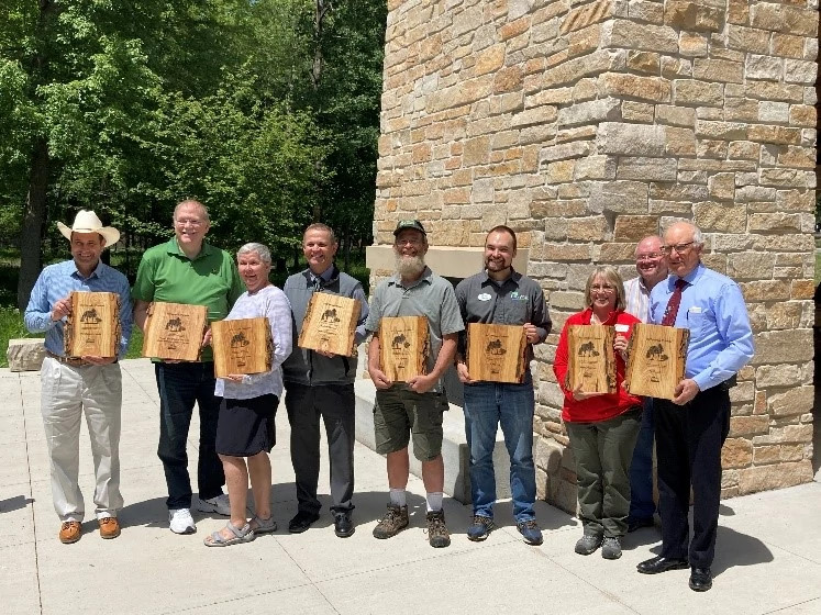 Recipients of the 2022 Invader Crusader Awards stand with their plaques at the annual awards ceremony held at Schmeekle Reserve on June 7, 2022.