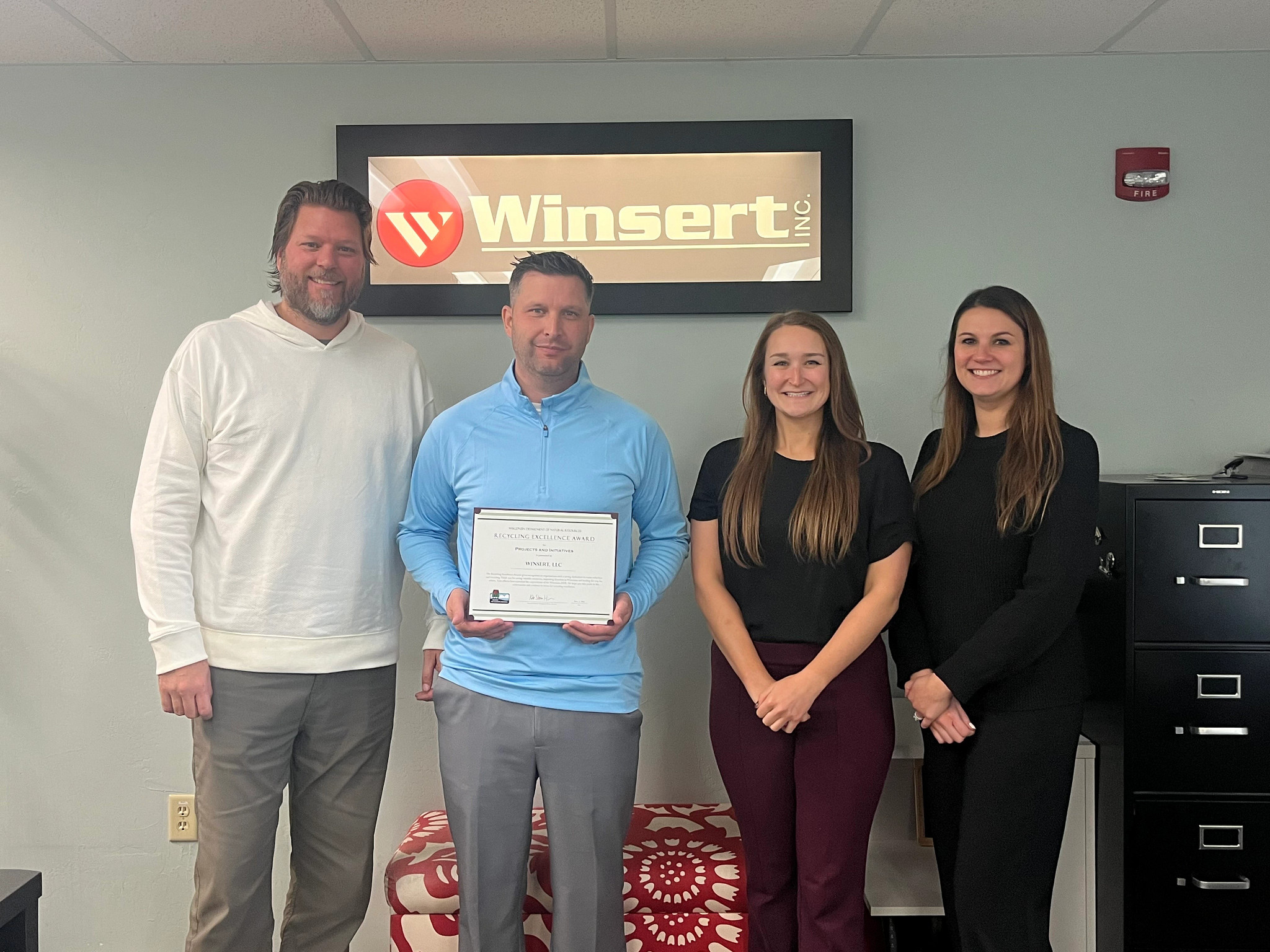 Employees of Winsert LLC posing with Recycling Excellence Award