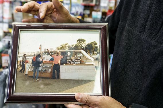 Tommy White holds photo of his father