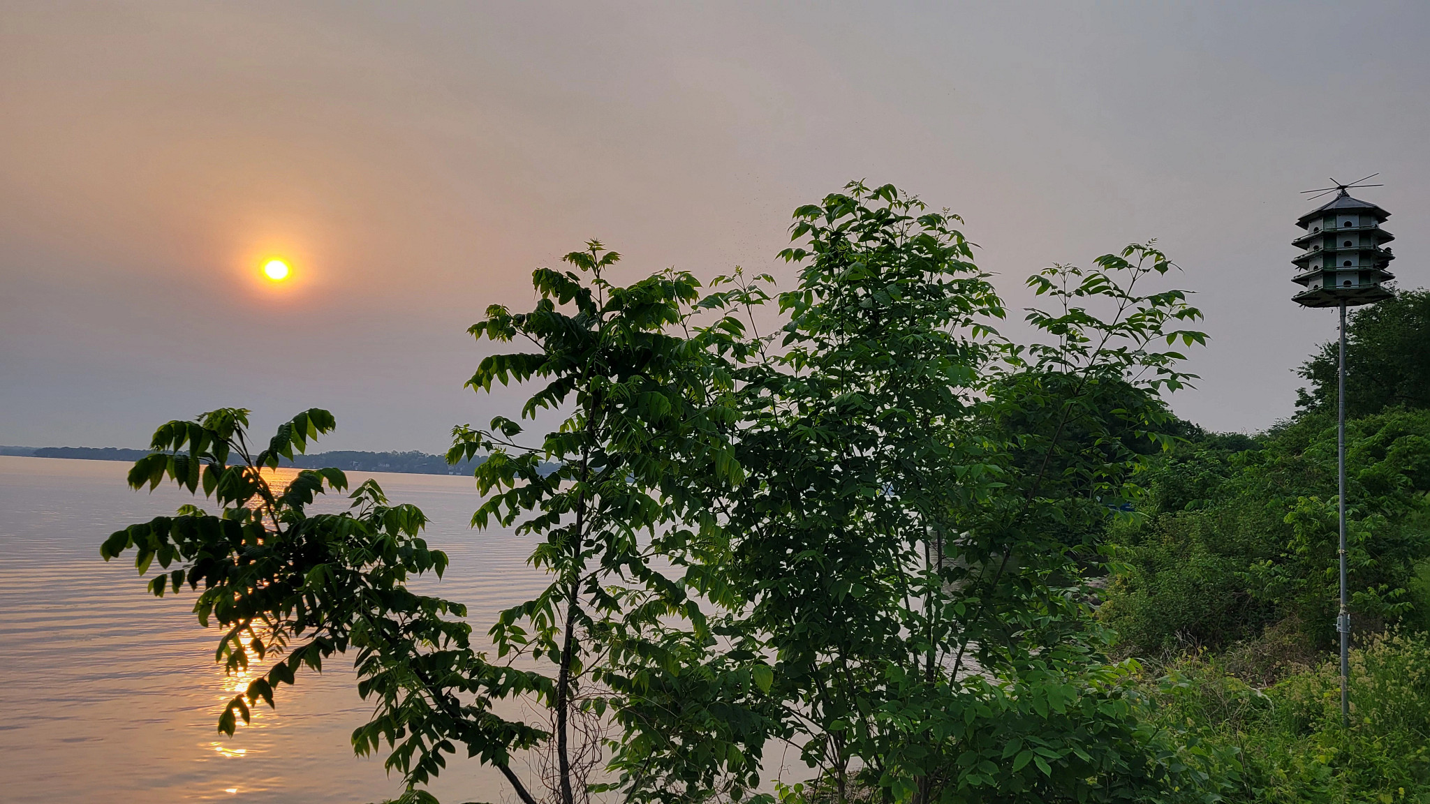hazy sunrise over lake monona in madison, wi