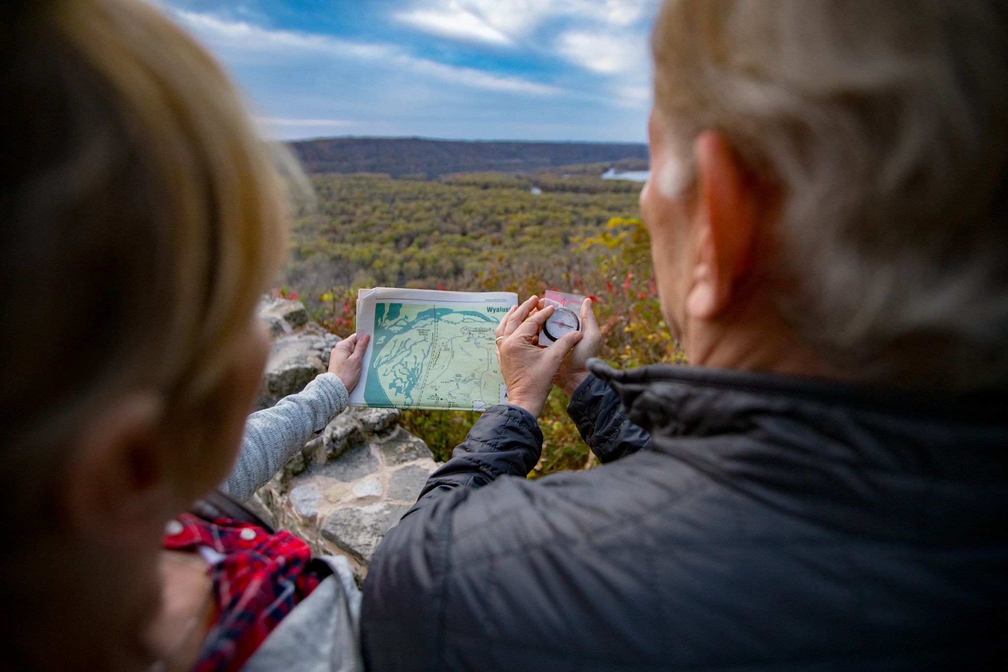 Couple looking at a map and a compass