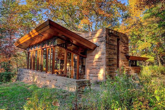 A photo of the Seth Peterson cottage with the sun shining down on it.