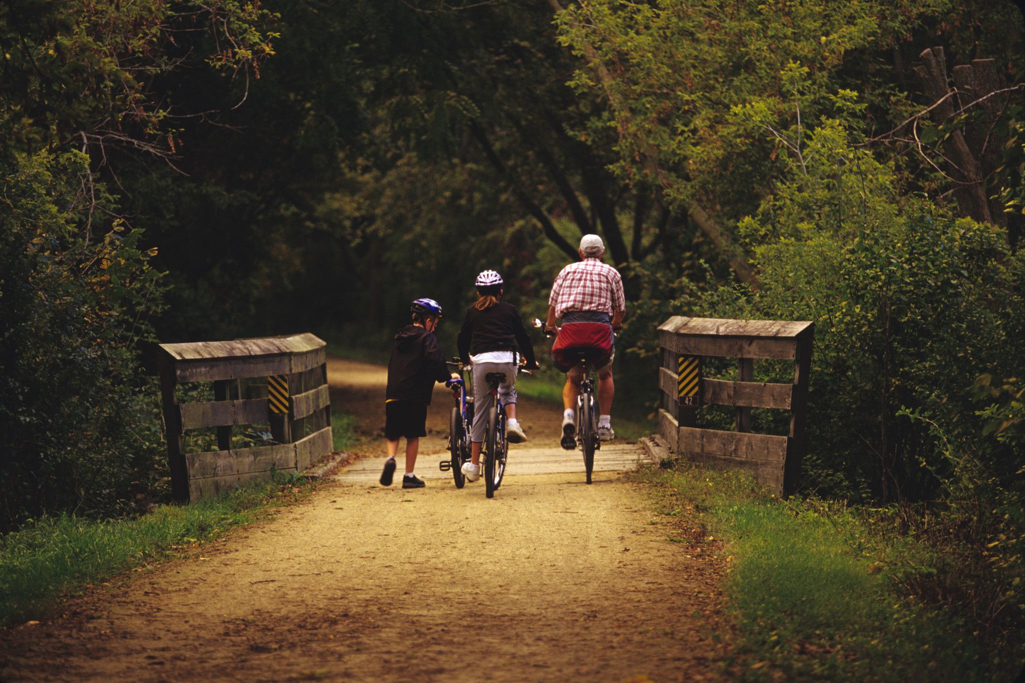 An image of a family riding their bikes at Military Ridge State Trail. 