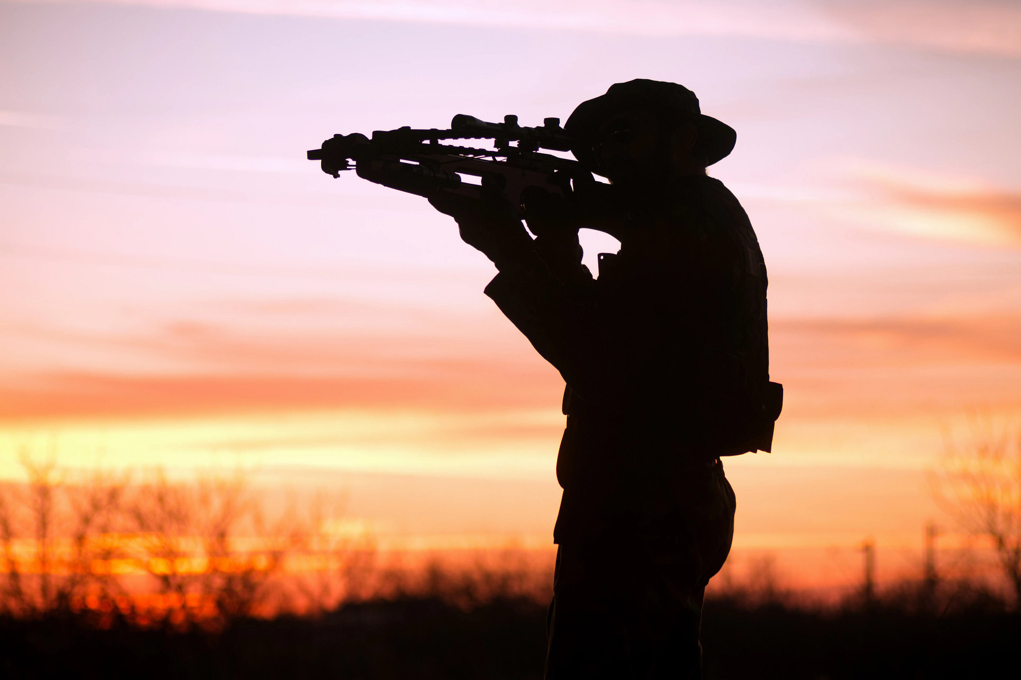 silhouette of man hunting with crossbow