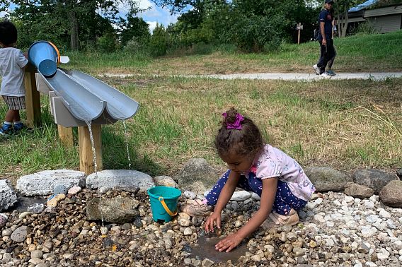 young girl plays in the outdoors