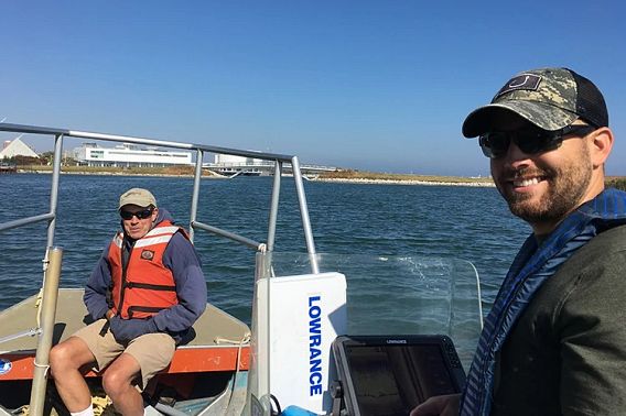 John Janssen and Brennan Dow in a boat during research