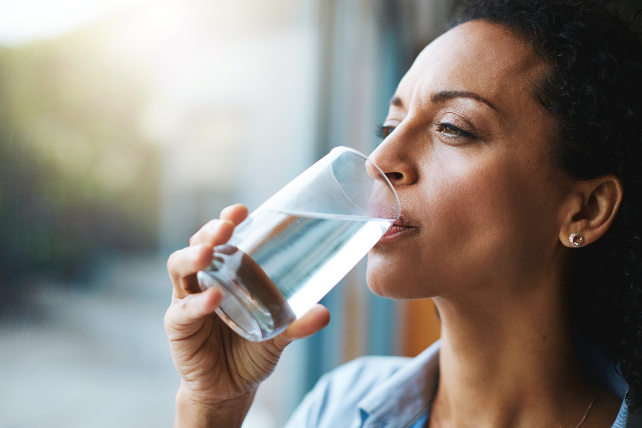 woman drinking a glass of water