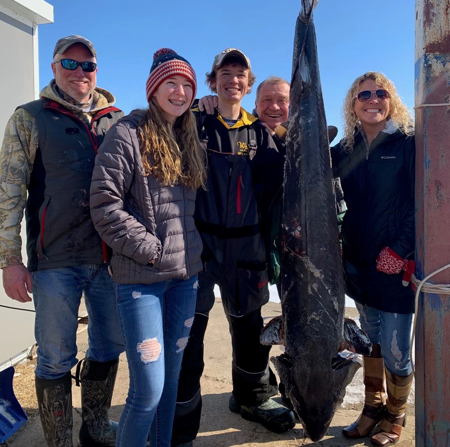 Family poses with lake sturgeon harvested.