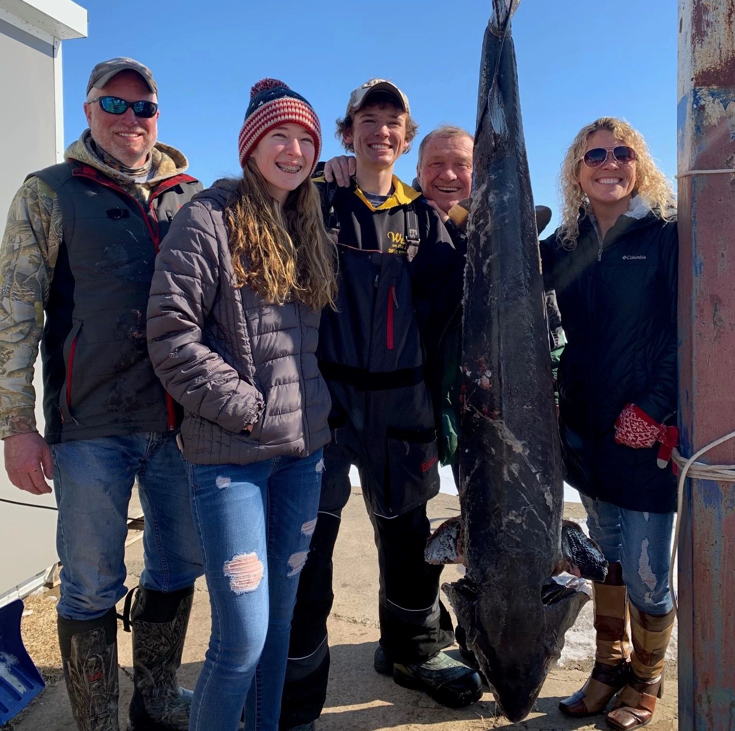 Family poses with lake sturgeon harvested. 