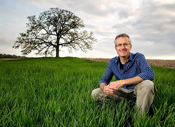 Mark Hirsch and bur oak in field