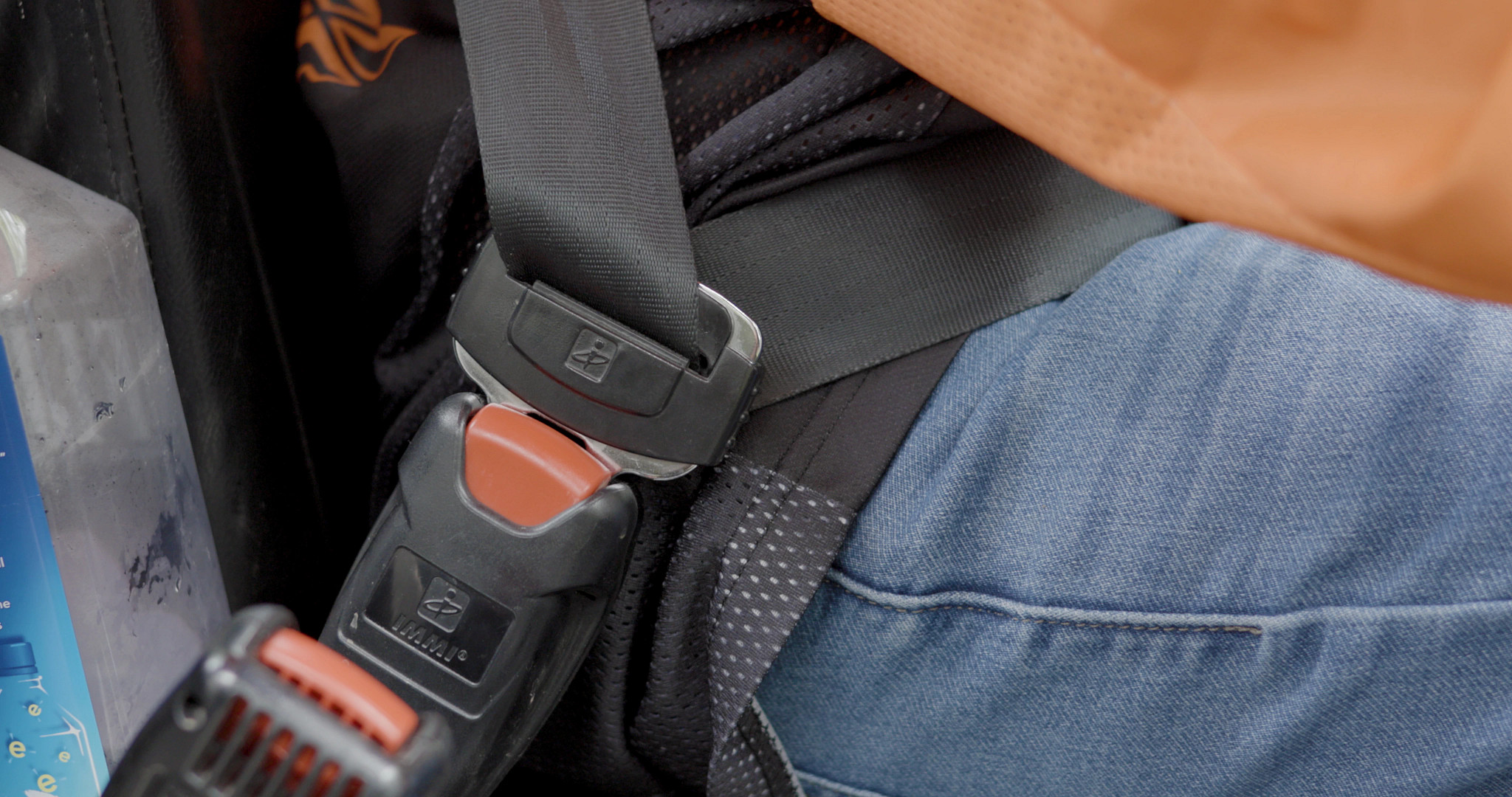 A close-up of a seatbelt buckled in a UTV. 