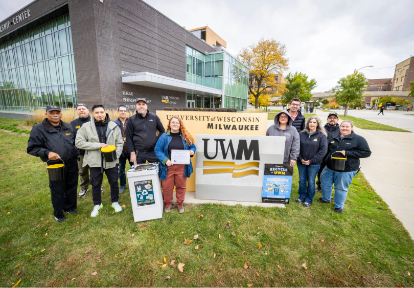 Employees and students of UW-Milwaukee posing with Recycling Excellence Award