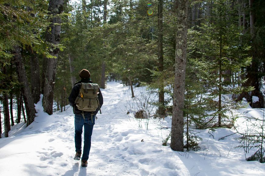 man hiking in winter at Copper Falls State Park