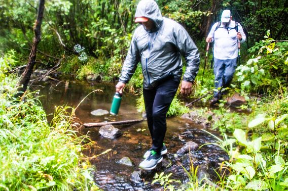 hiker crossing stream