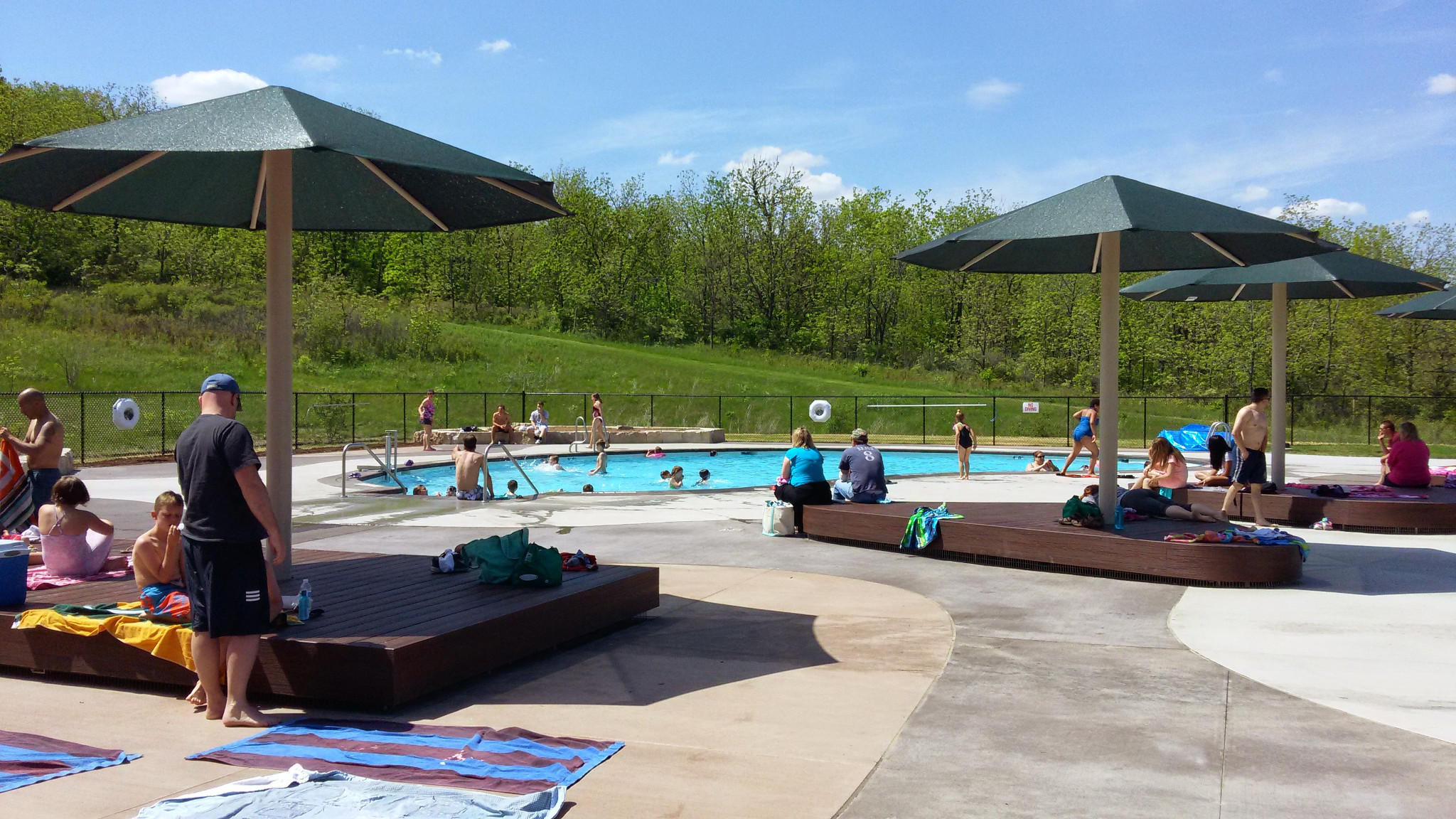 Kids and adults enjoy the shaded area and water at the splash pad.