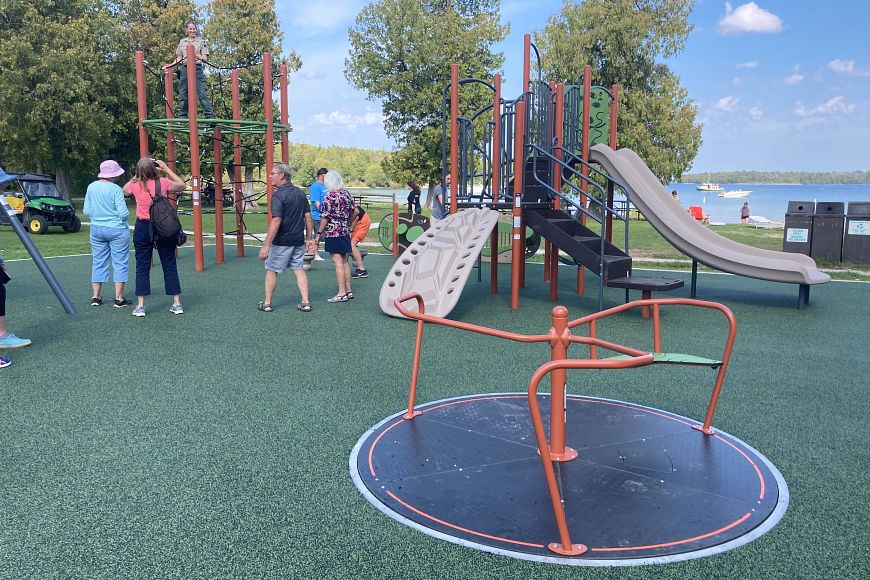 The new playground at Peninsula State Park with an accessible surface and accessible playground equipment, including a flush-mounted merry-go-round.