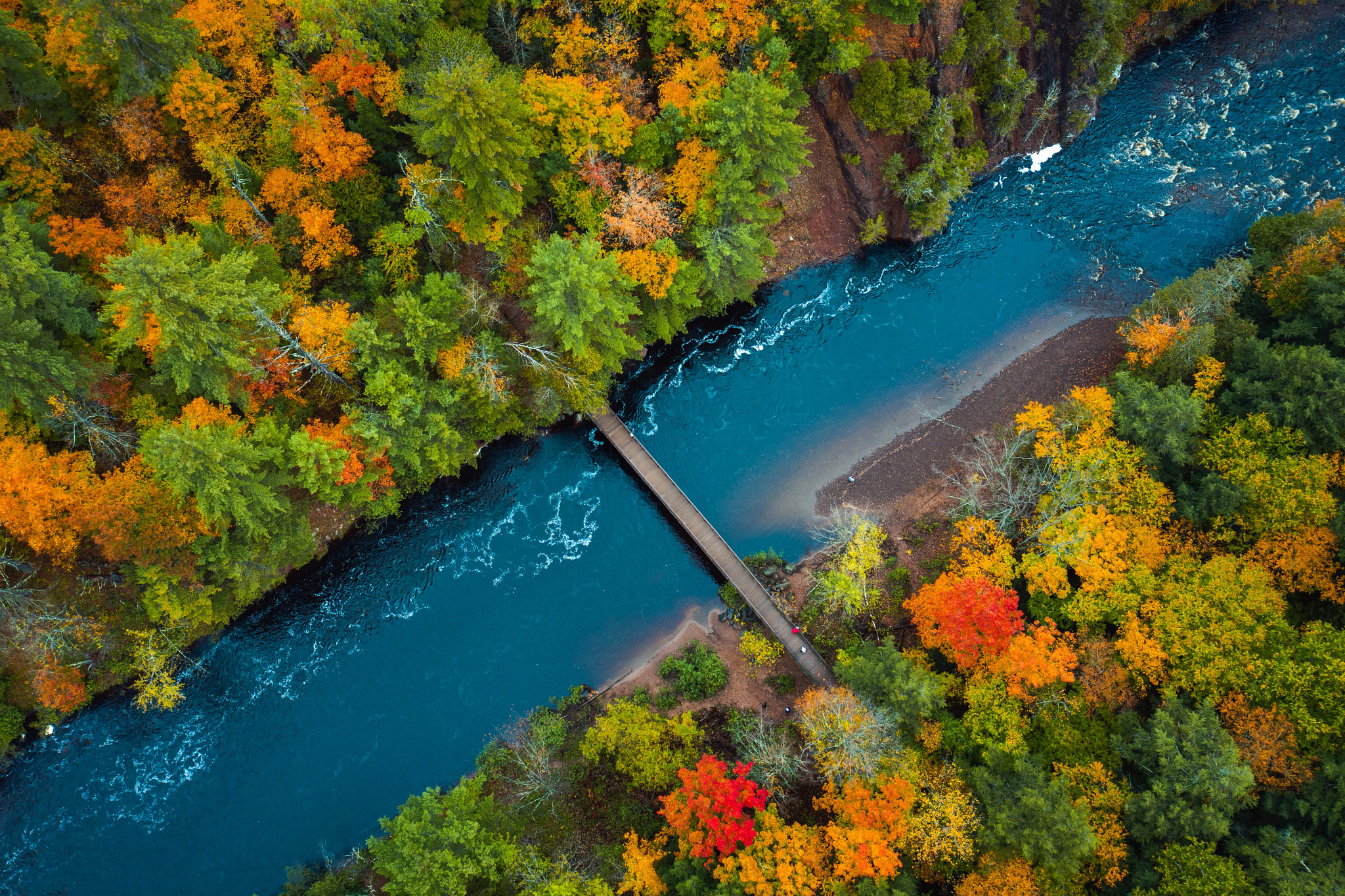 Aerial view of pedestrian foot bridge across the Bad River at Copper Falls State Park.