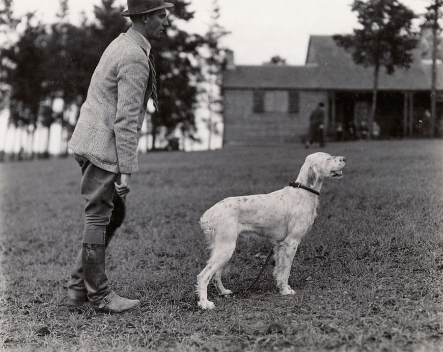 historic photo of a man with hunting dog