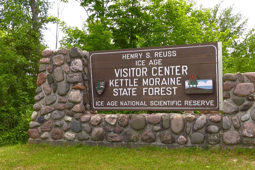 The entrance sign at the Visitor Center at Kettle Moraine State Forest on a sunny day.