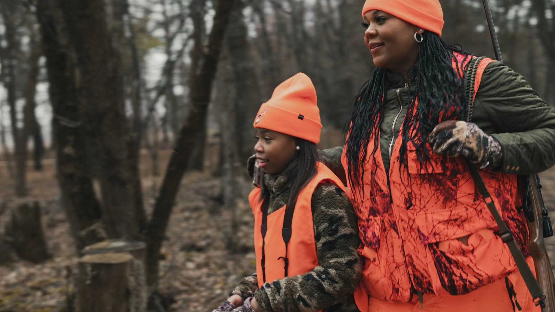 two women hunting together, wearing blaze orange
