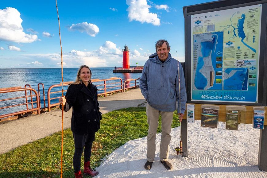 Kim Beckmann and John Janssen by maps signage on Milwaukee shore