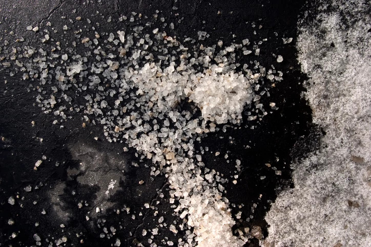 Salt on asphalt with snow right frame