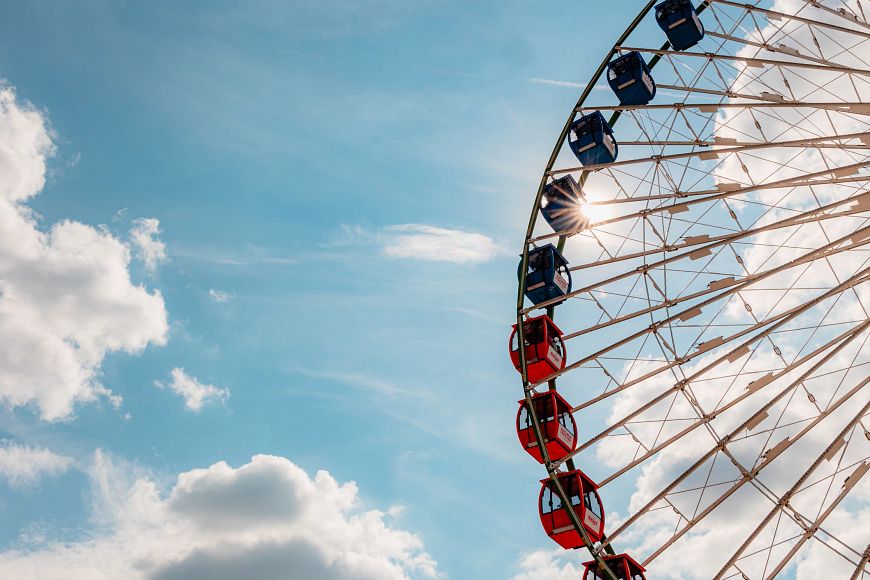 a ferris wheel at the Wisconsin State Fair in front of a blue sky with clouds