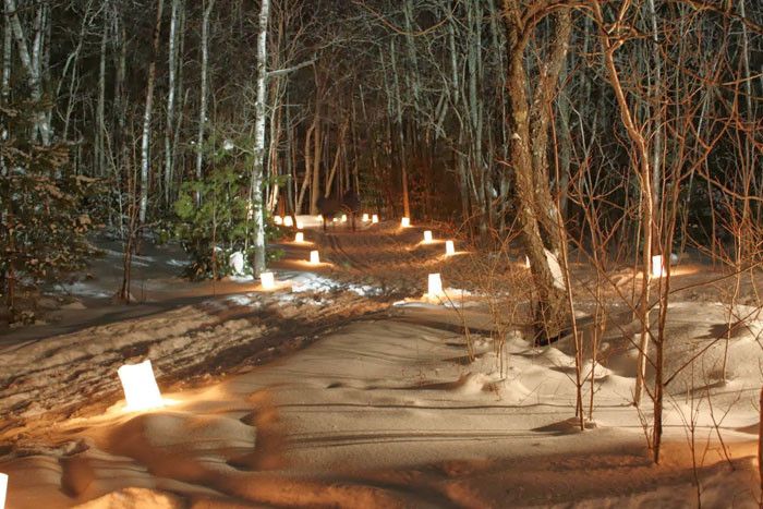 A snowy, candlelit trail 