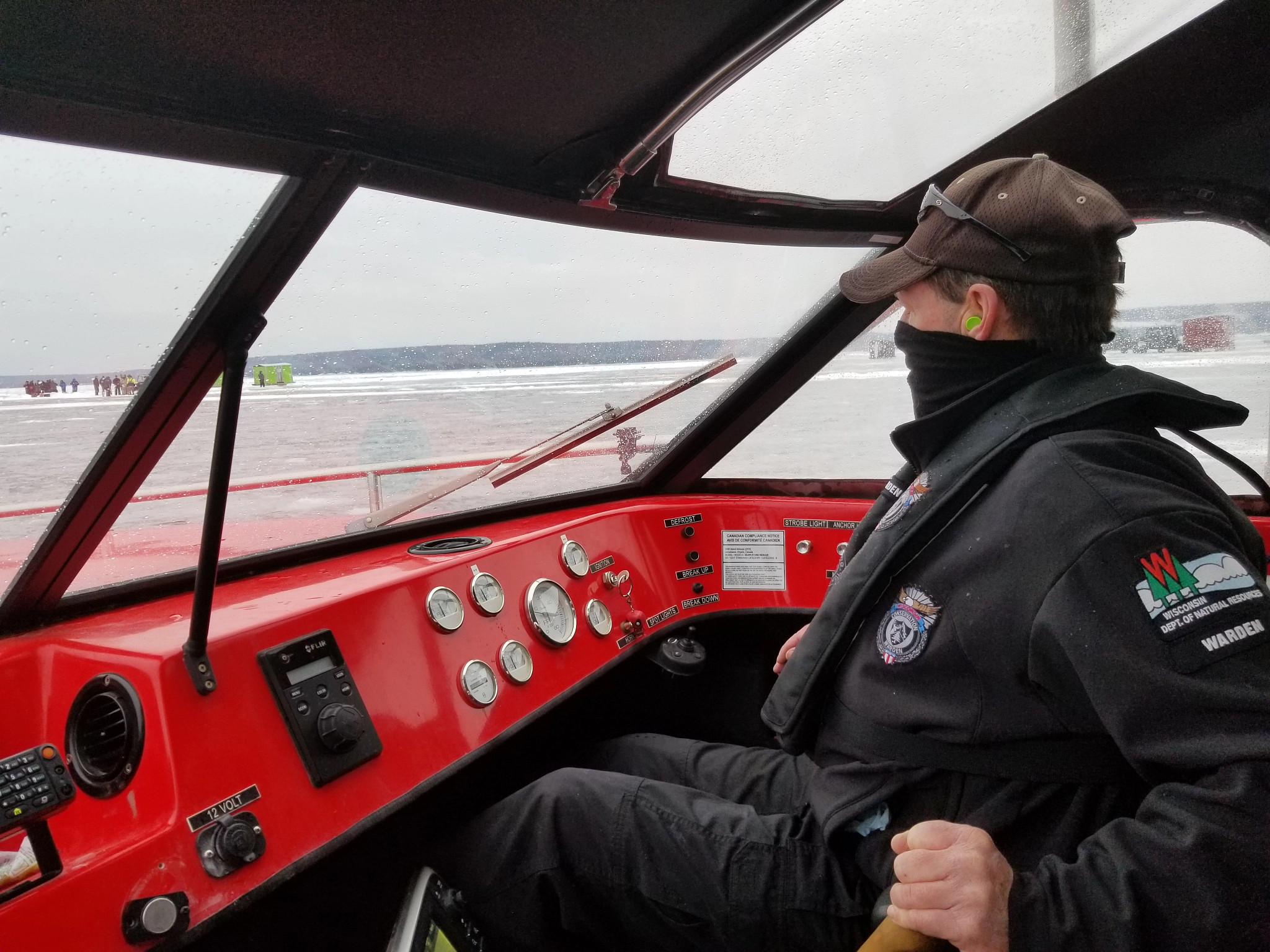  Marine Warden operates DNR airboat on rescue during winter.
