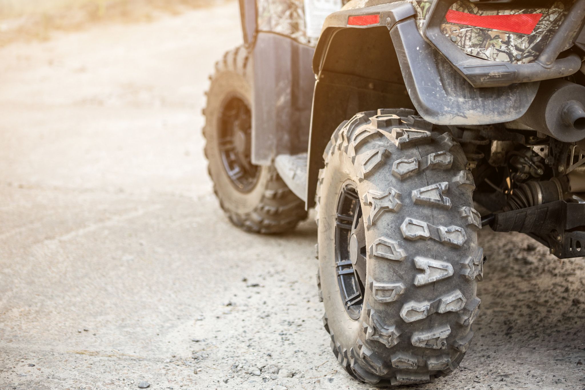 A close-up image of an ATV's tires. 