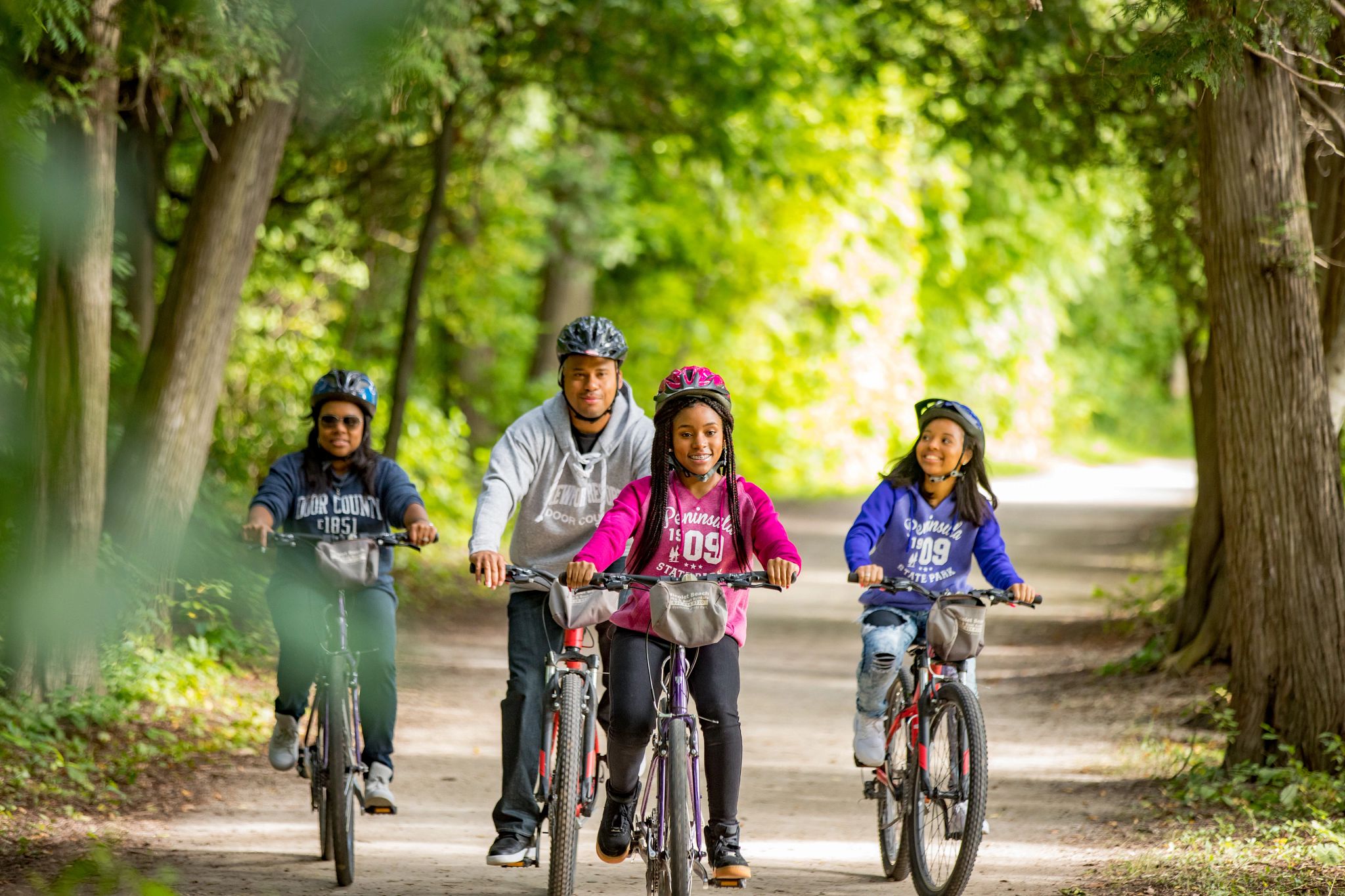 An image of a family biking together outdoors.