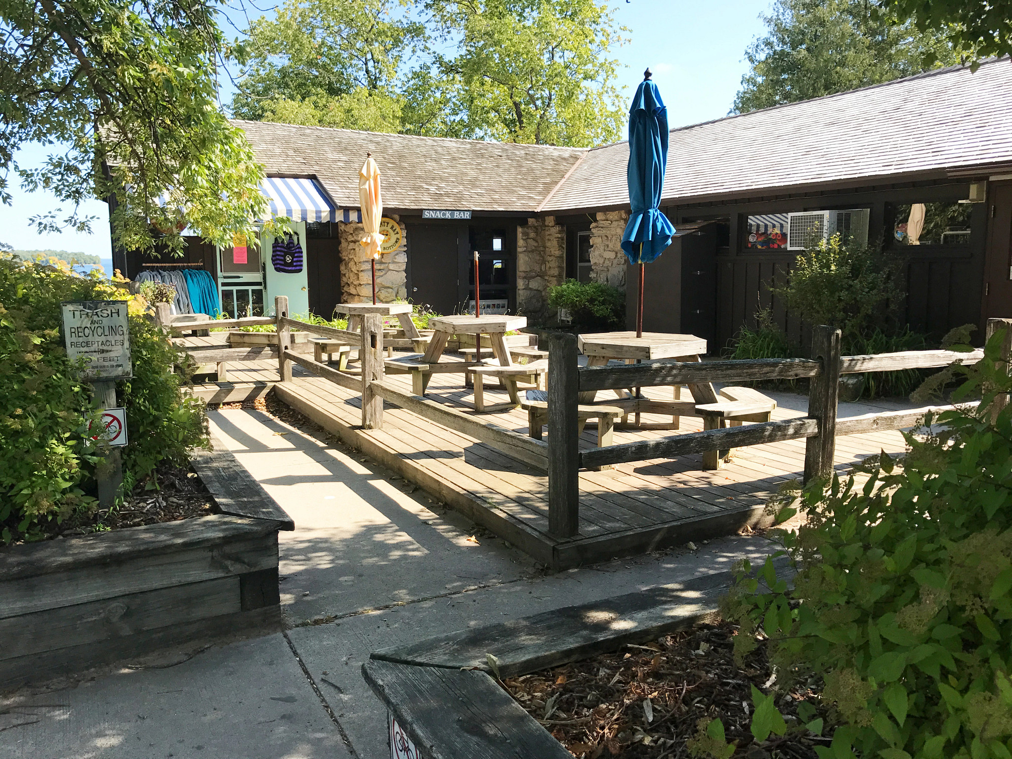 A wooded outdoor patio and chairs.