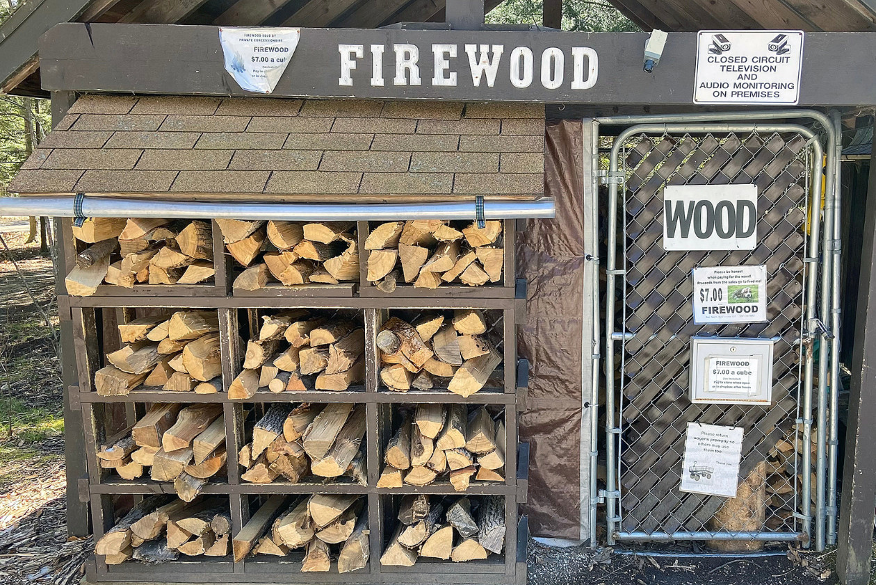 Firewood is stacked up at a kiosk at a state park.