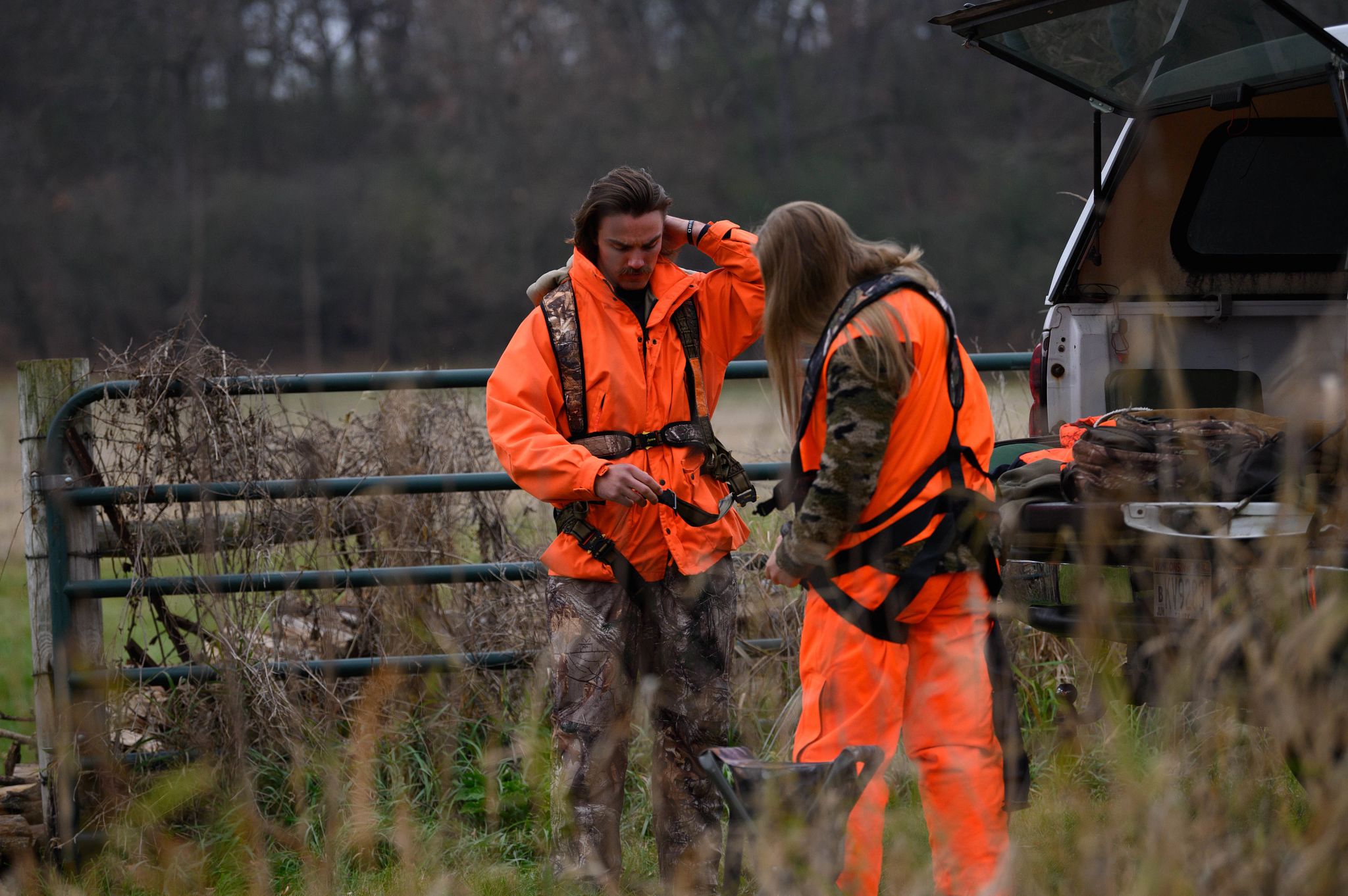 An image of two hunters prepping near their vehicle.