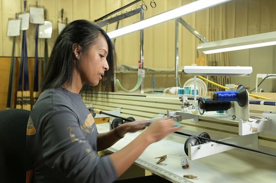 Woman operating a fishing rod machine