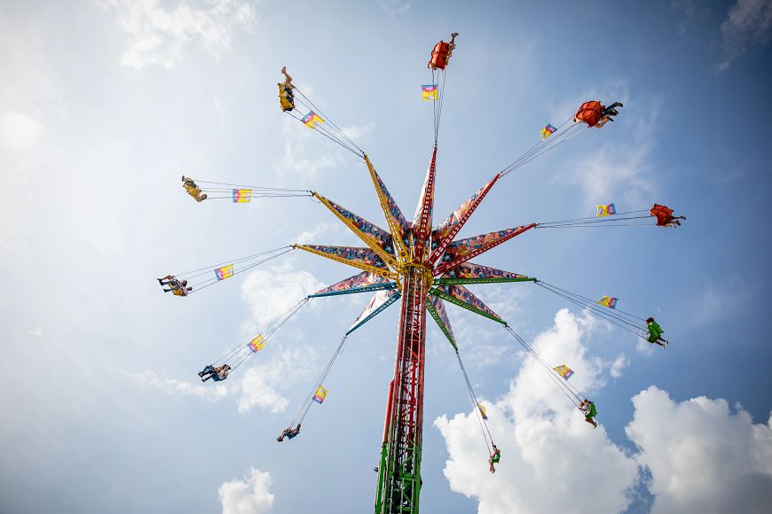 people riding a spinning ride at the Wisconsin State Fair