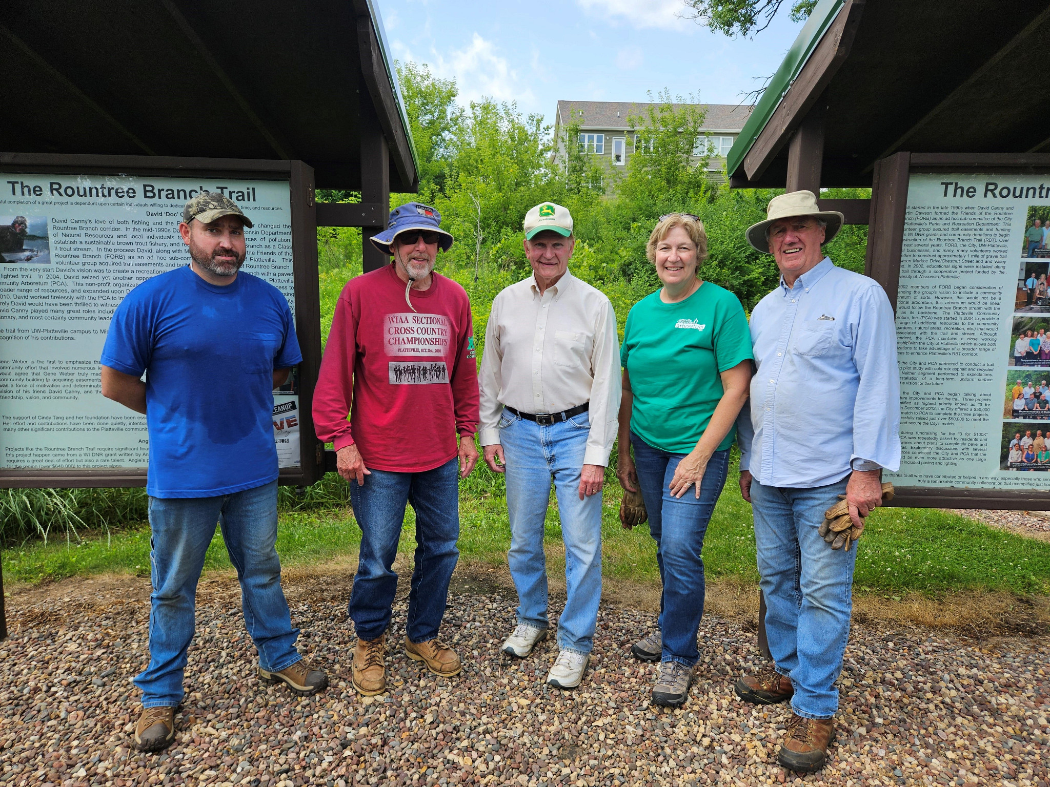 : A group of people stand together at an invasive species control workday.