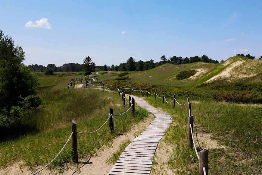 The boardwalk through the dunes at Kohler-Andrae State Park on a sunny summer day.