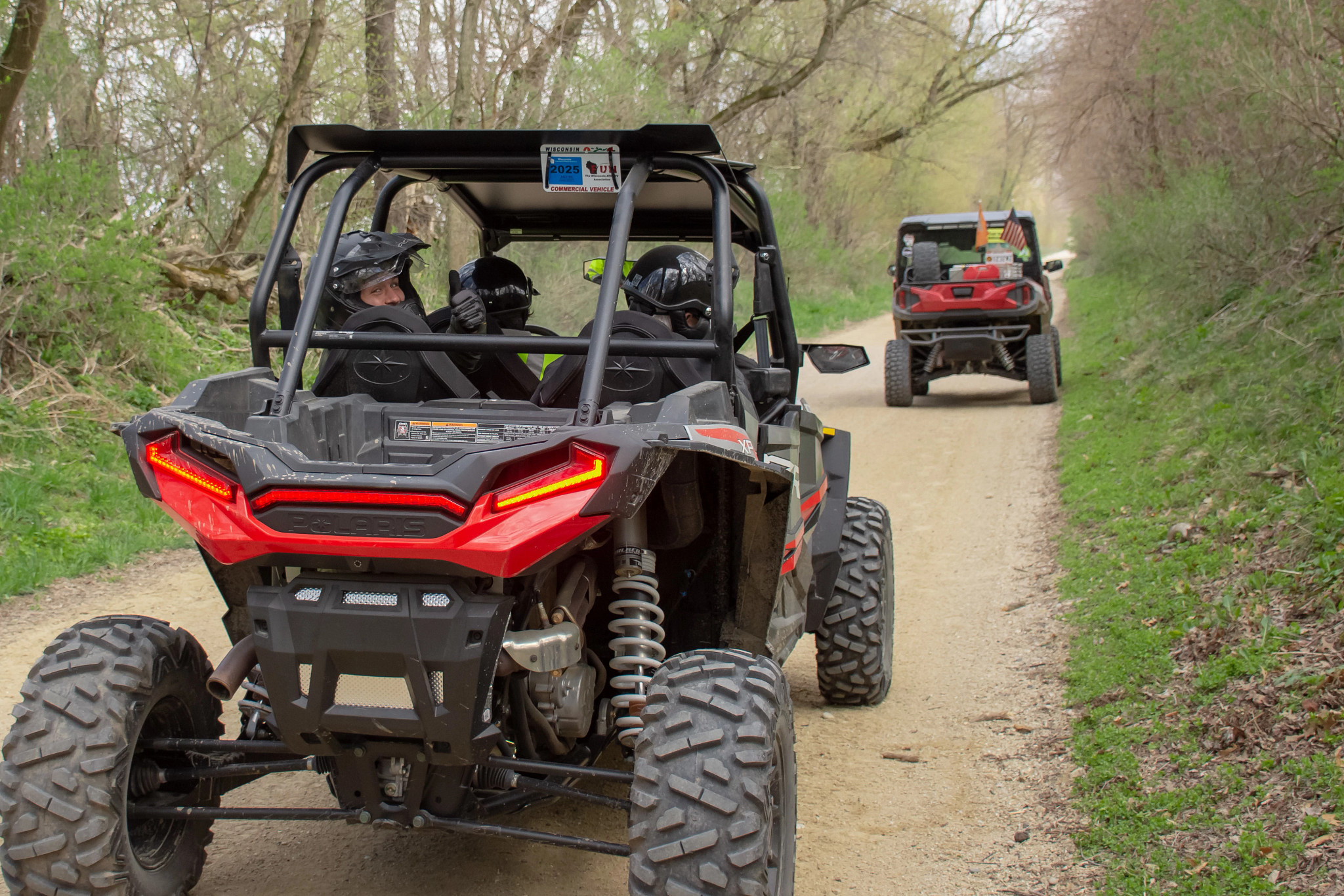two red atvs on a gravel atv path