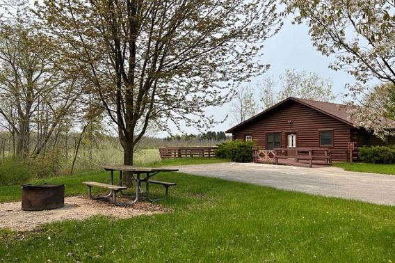 An accessible cabin next to a field at Kohler Andrae State Park. 